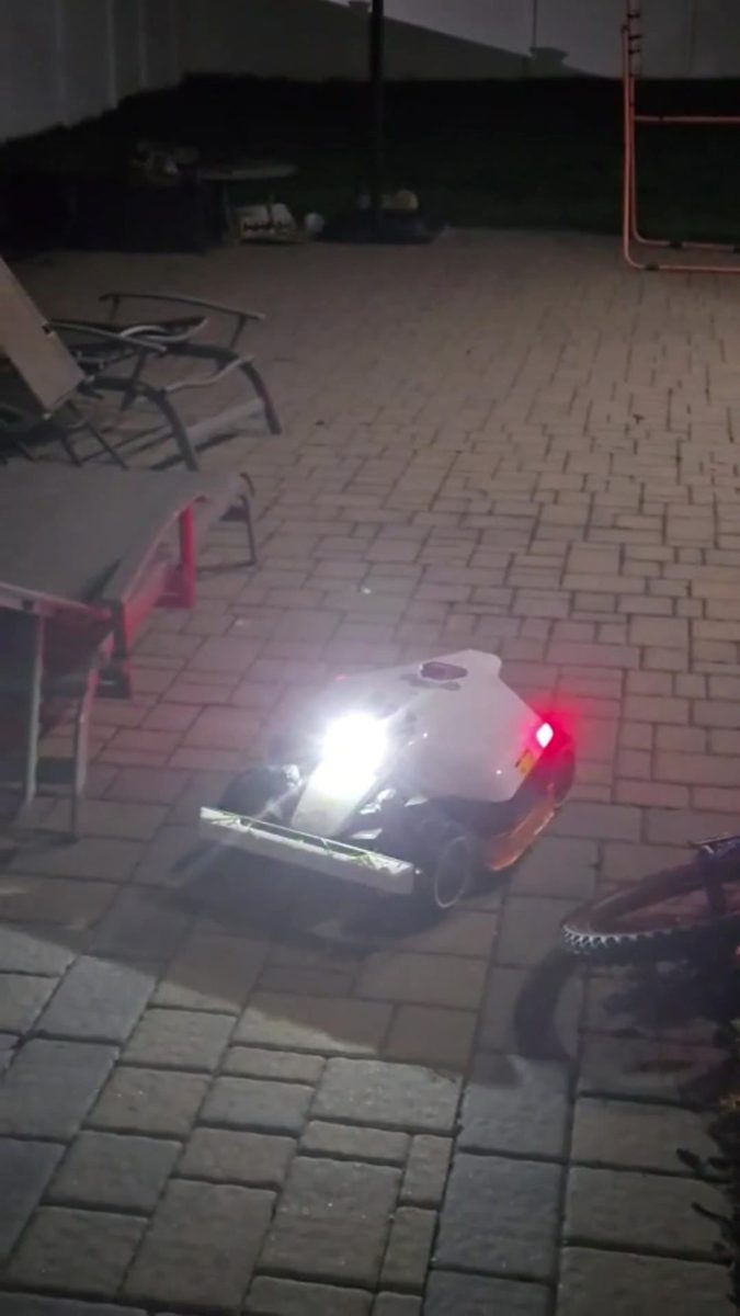 Mammotion Luba 3 AWD mowing at night with its lights on