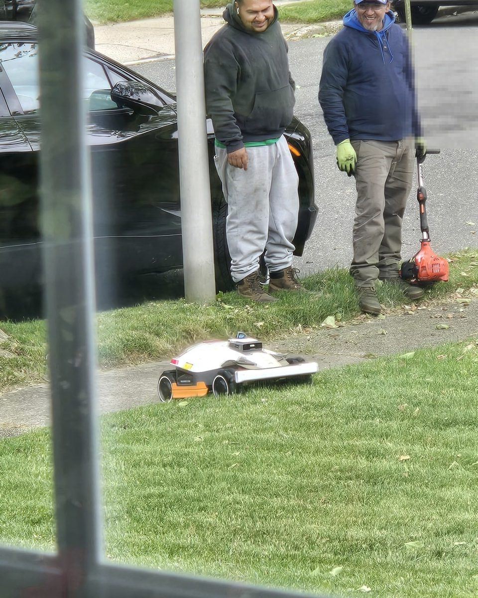 Landscapers smiling at the Luba 3 AWD robot mower